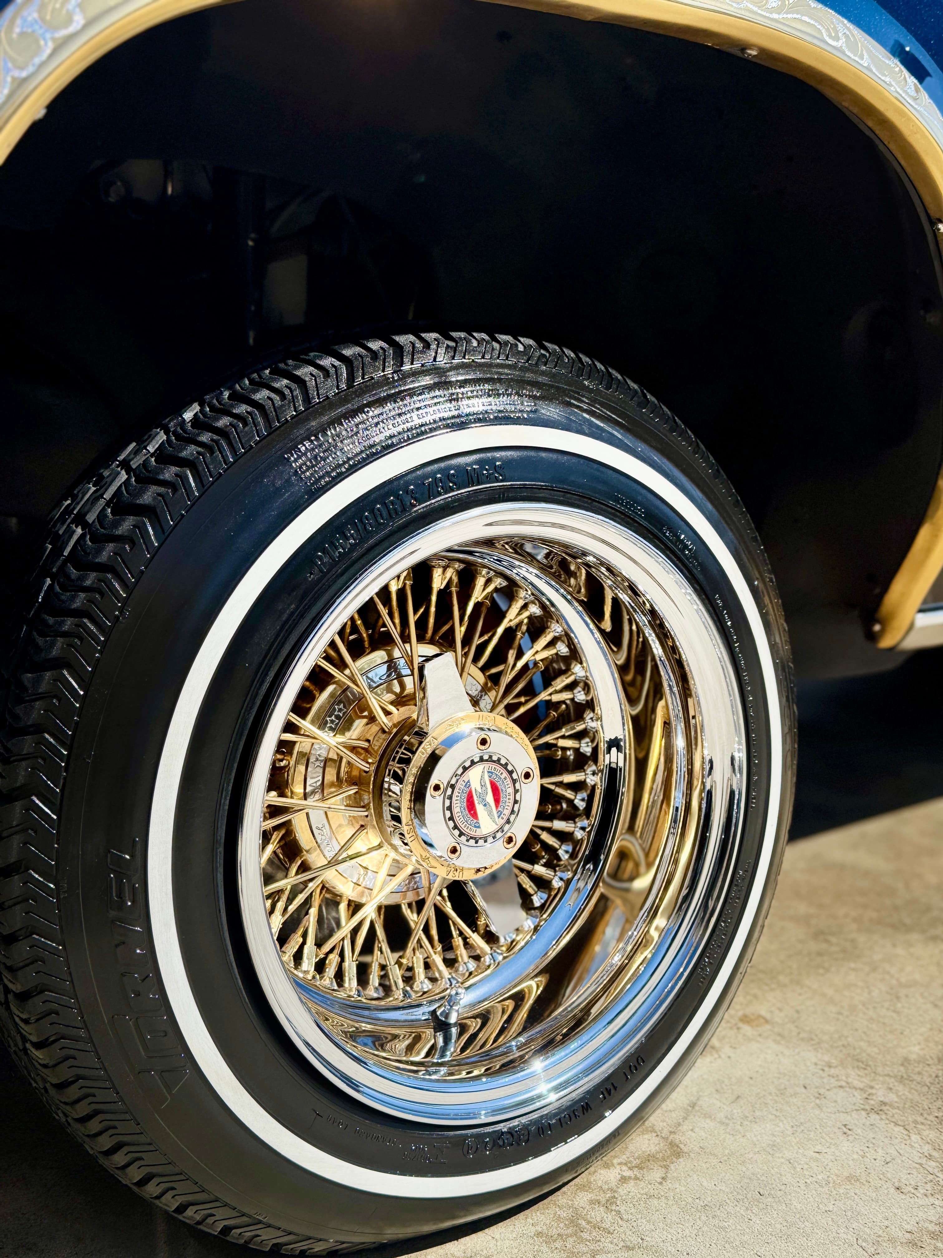 Gold wire spoke wheel with whitewall tire